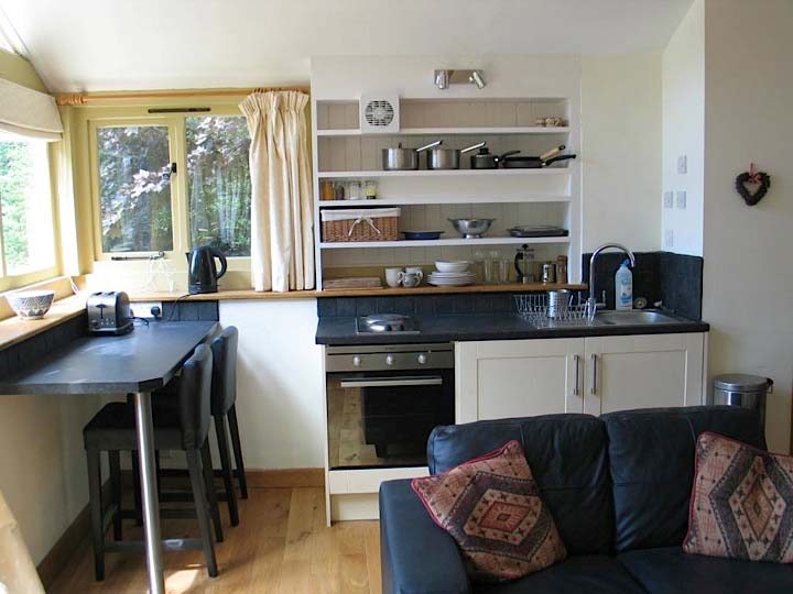 Nuthatch Chalet: interior, showing the kitchen area, the breakfast bar and the sofa