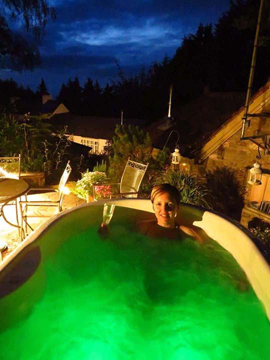 Enjoying the hot tub with a glass of wine.